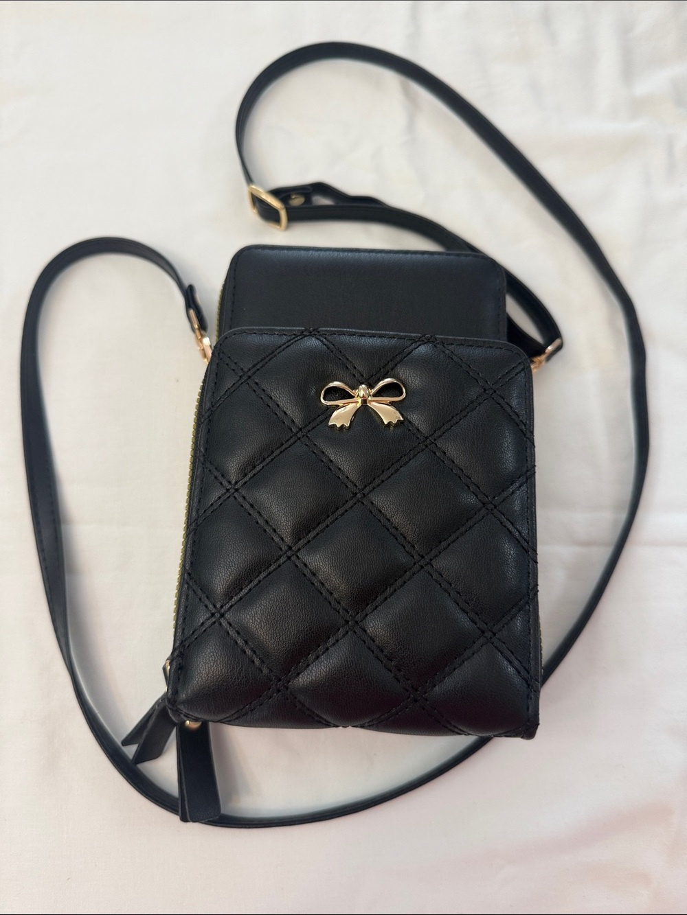 Chic Unlimited Black Quilted Crossbody Phone Bag with Gold Bow Accent
NWT